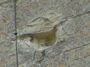 "Face" high on the church tower. May be from civil war damage