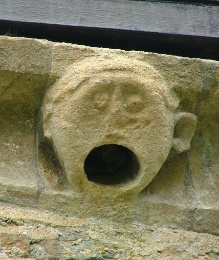 Gaping Mouth under the eaves of the church